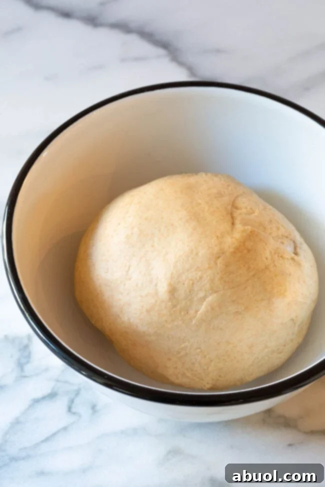 Let the dough ball rise in the bowl