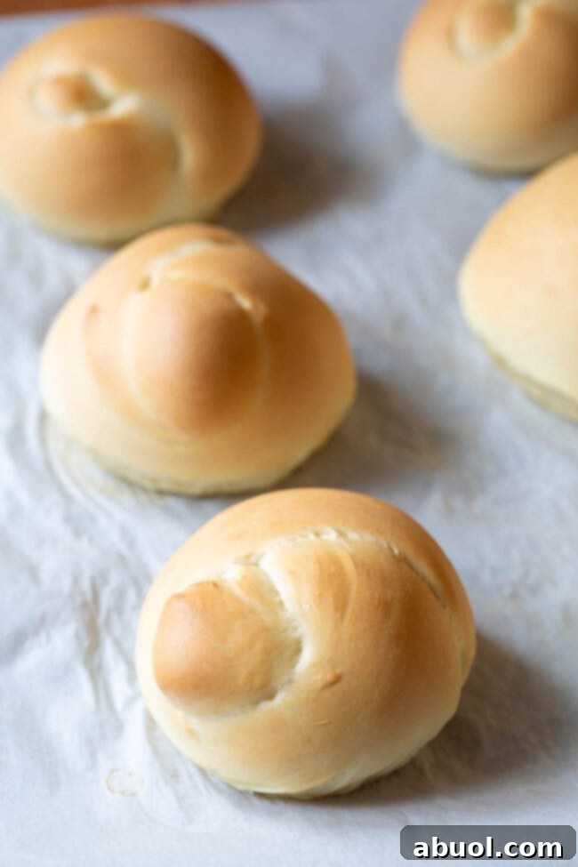 Freshly baked bread knots cooling on a wire rack, before being coated in the savory garlic herb butter.