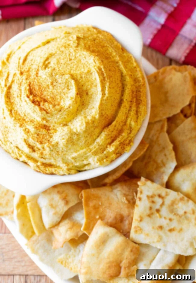 Irish Pub Cheese AKA Beer Cheese in a small crock next to pita chips.