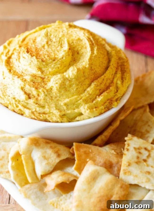 Beer Cheese Dip (Pub Cheese) in a small bowl with a sprinkle of paprika.