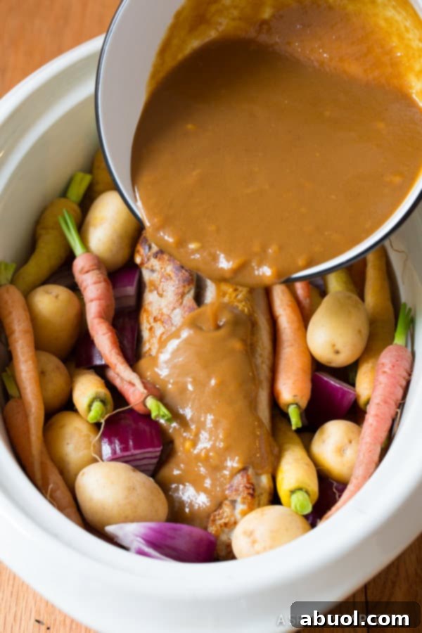 Pork Loin Gravy poured over Crock Pot Pork Loin with Vegetables