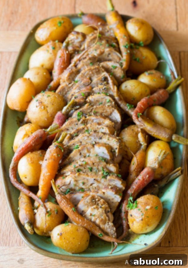 Crockpot Pork Loin with Vegetables on platter with potatoes, carrots, and onions