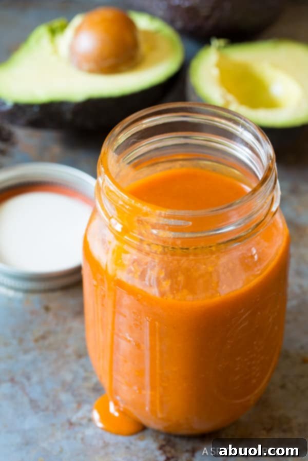 Homemade Catalina Dressing in a rustic glass mason jar, showcasing its vibrant color and smooth texture.