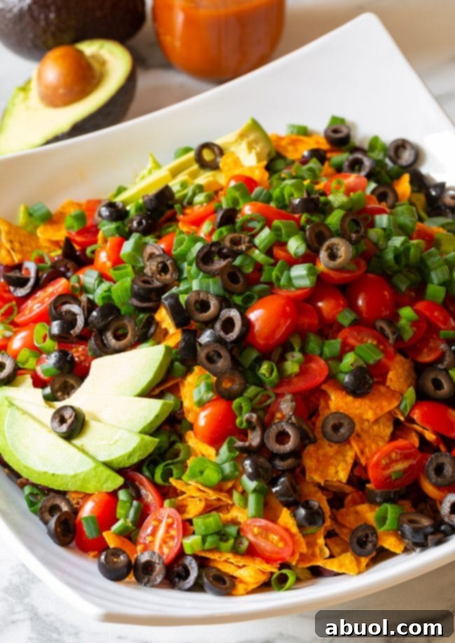 Crushed Nacho Cheese Doritos, the signature crunchy element of this ultimate taco salad.