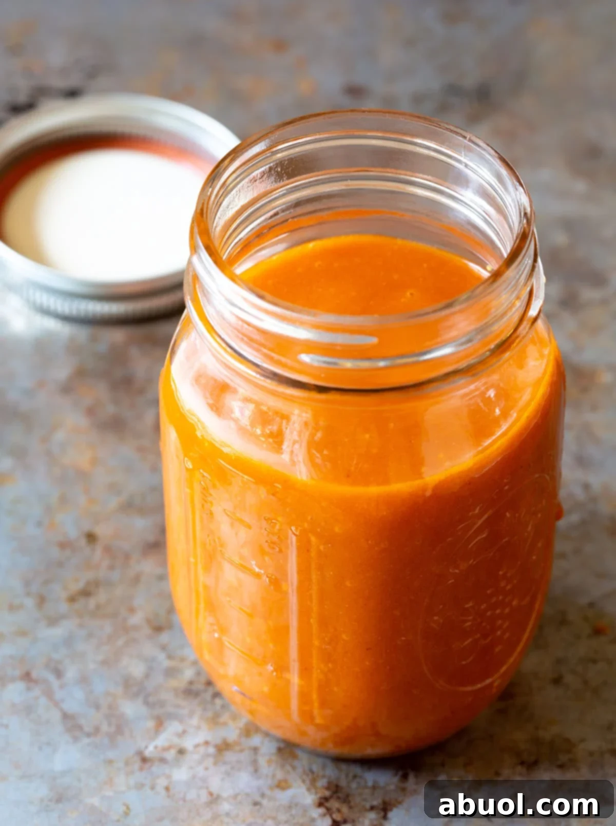A beautifully presented mason jar filled with amazing homemade Catalina dressing, ready to be enjoyed.