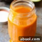 Homemade Catalina dressing with a fresh avocado slice, showcasing the vibrant color and creamy texture of the dressing.