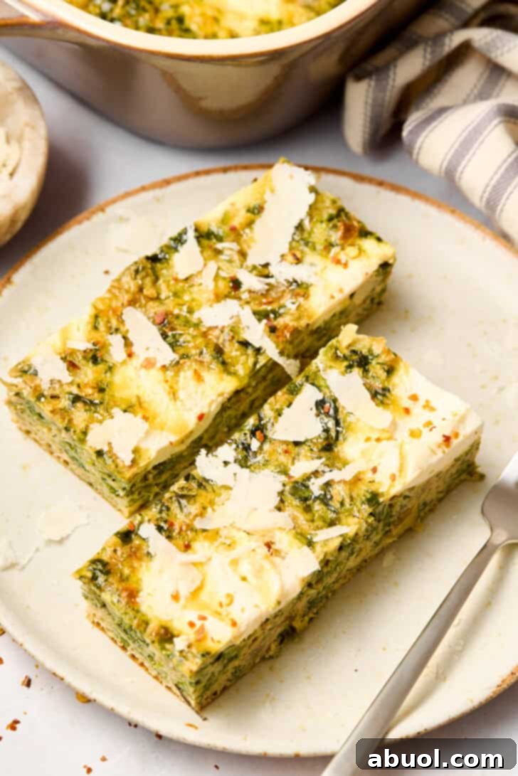 spinach artichoke casserole cut on plate, ready for serving