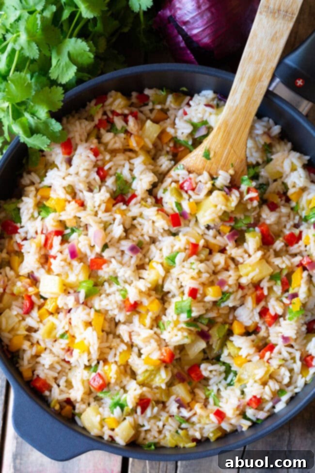 Flavorful Caribbean Confetti Rice simmering in a skillet, ready to be served.