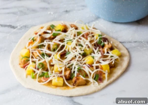 Expert tips and visuals on how to make the Best Grilled Chicken Teriyaki Pizza, a signature recipe from ASpicyPerspective.com.