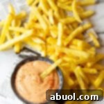 A small bowl of Comeback Sauce with a serving spoon.