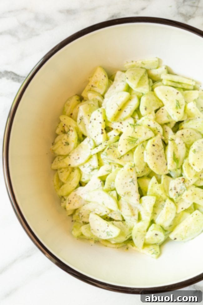 Large bowl of creamy dill cucumber salad, perfect for any summer potluck or gathering.