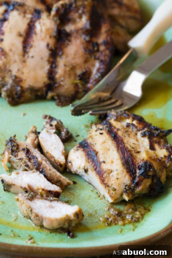 Easy Jerk Chicken Thighs, sliced on a plate to show the juicy interior, ready to be eaten.