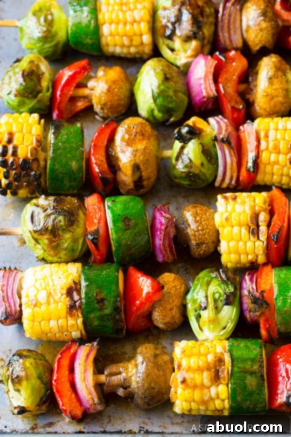 Delicious Grilled Vegetable Kabobs featuring vibrant summer vegetables like corn, zucchini, peppers, and onions, all coated in a zesty fajita butter and threaded onto skewers.