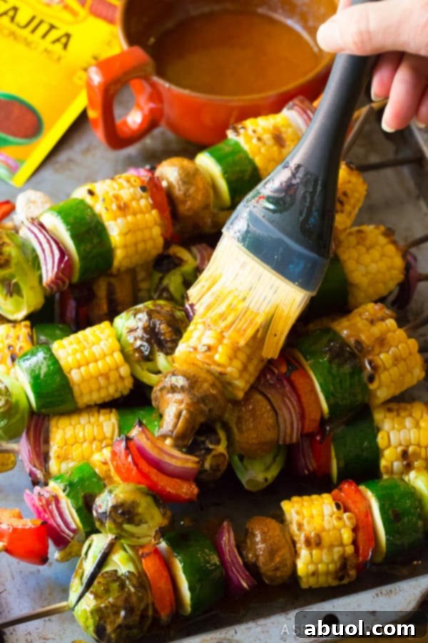 A beautifully plated serving of grilled vegetable kabobs, glistening with fajita butter, ready to be enjoyed as a summer side dish.