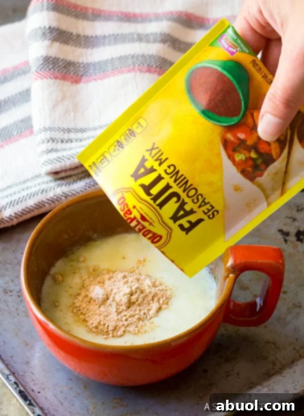 Ingredients for Fajita Butter - melted butter, lemon juice, and fajita seasoning - being whisked together in a bowl.