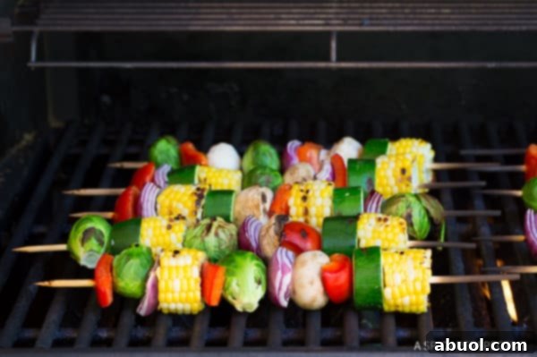 Grilled vegetable kabobs arranged on a grill, showcasing perfect char marks and golden hues on the vegetables.
