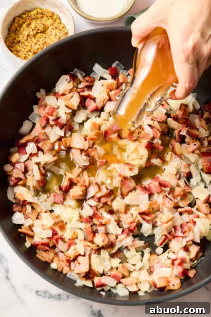 Cooking onions and bacon for warm potato salad