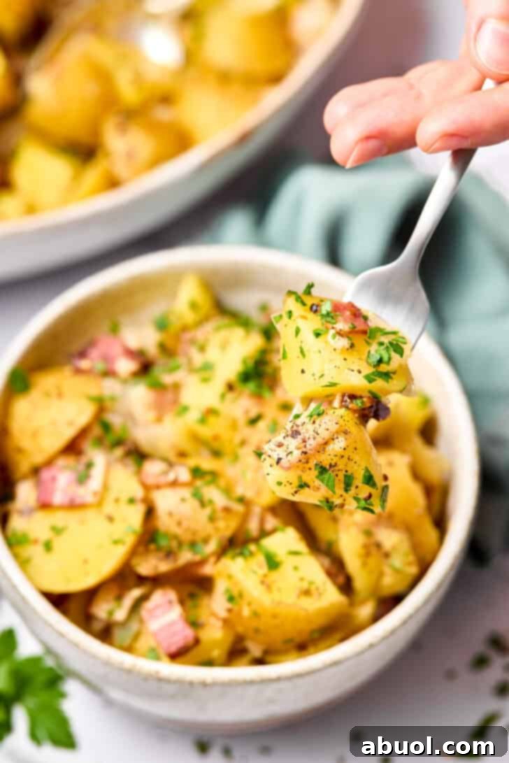 bite of hot potato salad on fork