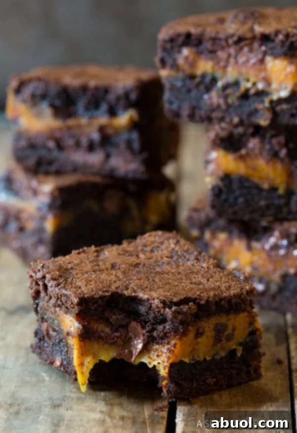 Caramel Stuffed Brownies - front brownie with a bite taken out, revealing the soft, gooey caramel filling.