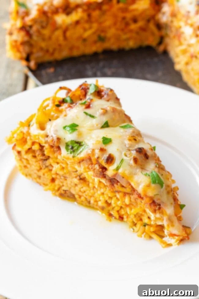 Multiple slices of baked spaghetti pie arranged on a platter, showcasing the golden-brown topping and inviting layers, ready for serving.