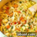 Final chicken tortellini recipe on the stove simmering in low heat
