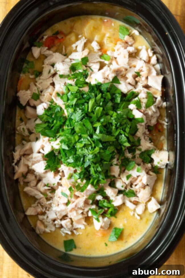 chicken potato soup in the slow cooker with chopped parsley.