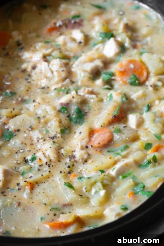 Slow cooker potato chicken soup in the crock pot after cooking. 