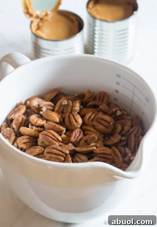 A bowl filled with whole pecans, ready to be incorporated into the caramel filling.