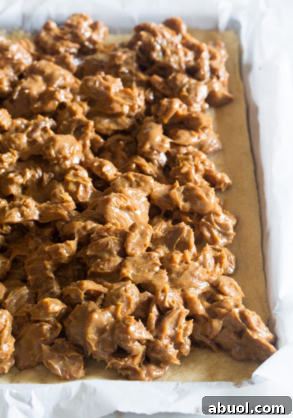 A perfectly baked cookie pie base, topped with the rich caramel pecan mixture before its final bake.