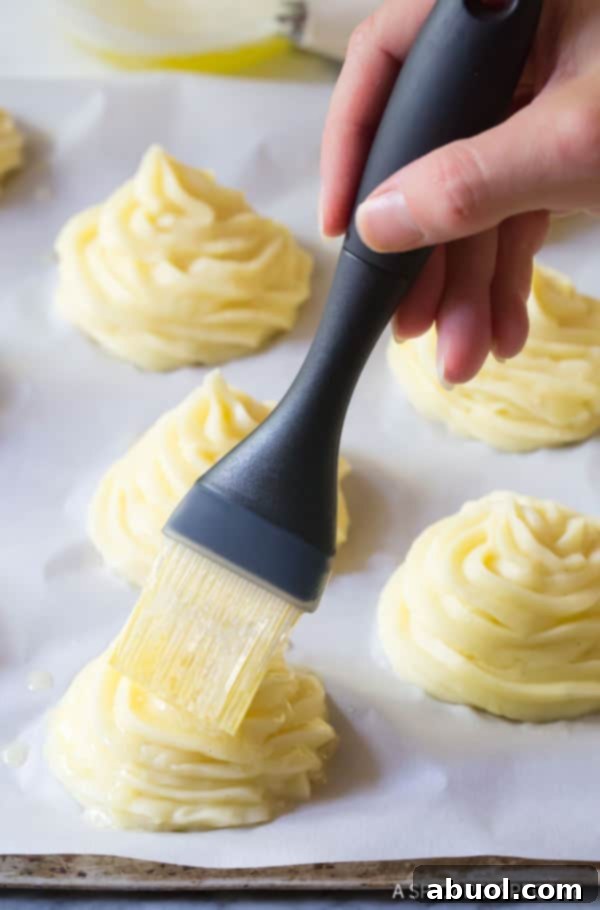 Duchess Potato on baking sheet, brushed with butter