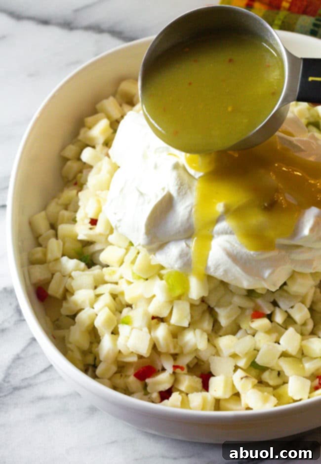Creamy ingredients, including sour cream and salsa verde, being poured over the thawed potatoes in a casserole dish.