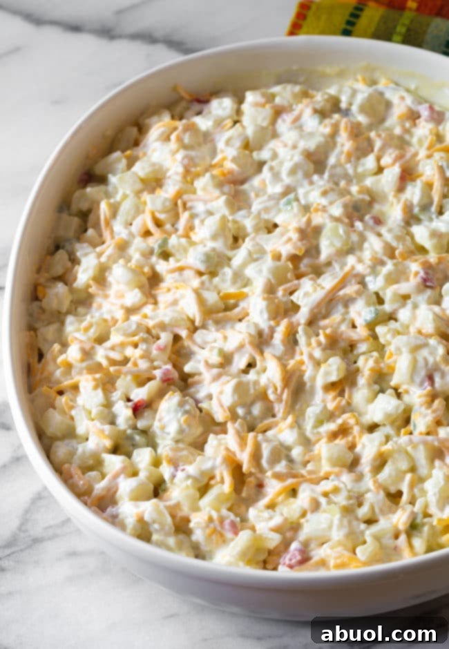 All the creamy ingredients thoroughly mixed with the potatoes in the casserole dish, ready for topping.