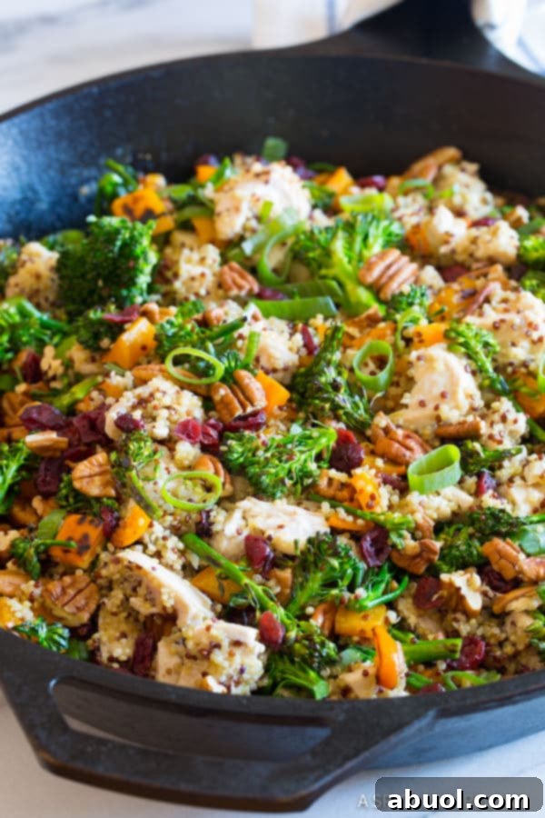 Chicken Broccoli Quinoa Skillet Recipe close up in pan with nuts and scallions