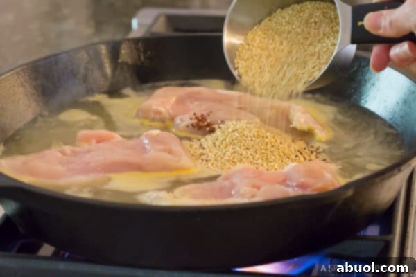 Healthy One-Pot Chicken Broccoli Quinoa - adding quinoa to the pan
