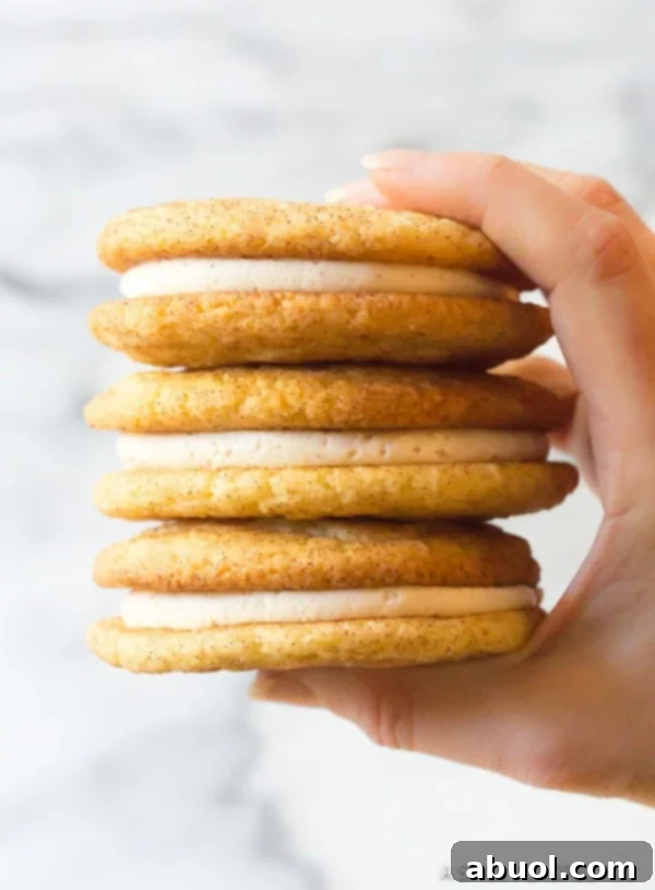 Best Snickerdoodles Cookie Recipe with frosting held in hand