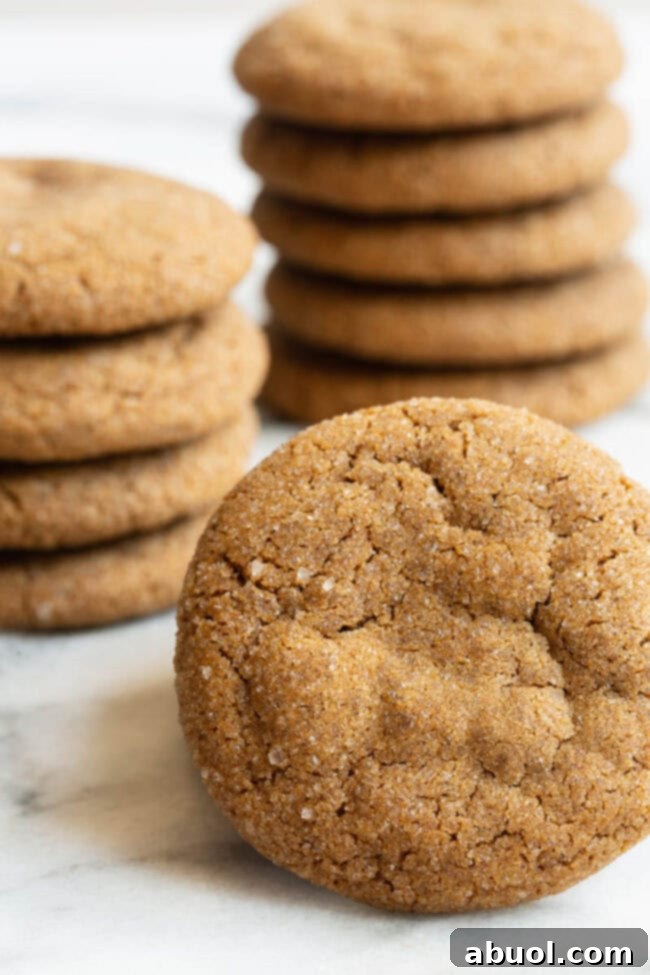Easy Molasses Cookies displayed on a wooden board with autumn leaves