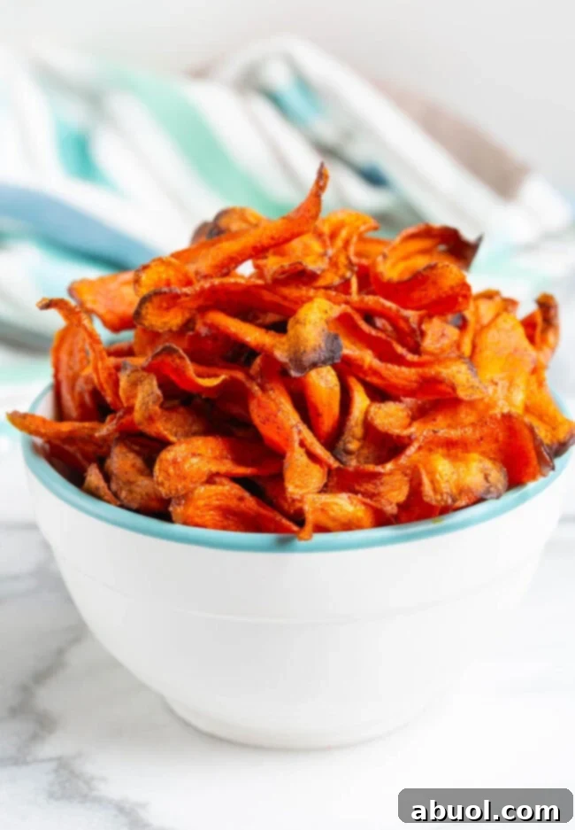 Healthy Baked Carrot Chips Recipe Crispy baked carrot chips piled high in a bowl, ready for a healthy snack.