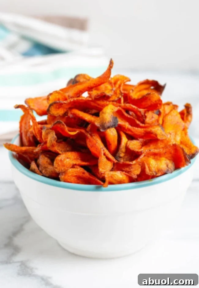 Crispy and Healthy Carrot Chips A bowl of delicious carrot chips with a title overlay indicating their healthy nature.