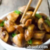 Asian Stir Fried Mushrooms Recipe served in a white bowl.