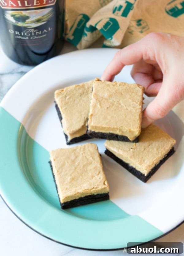 Awesome Baileys Irish Cream Coffee Bars for Saint Patrick's Day, with a hand reaching for a piece