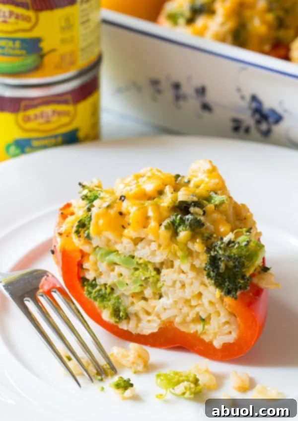 Broccoli rice and cheese stuffed bell pepper recipe - cut in half on a plate. 