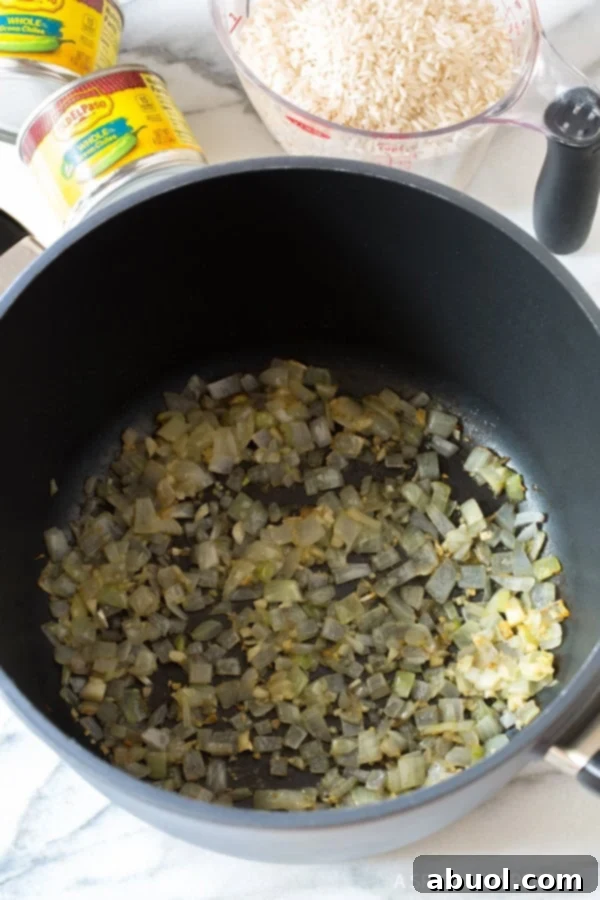 Onions and garlic being sauteed in pan. 