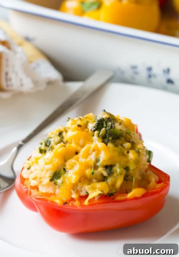 Broccoli and cheese stuffed bell pepper on a plate. 