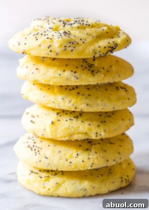 Lemon poppy seed cookies stacked on top of each other, showcasing their soft texture and vibrant color.