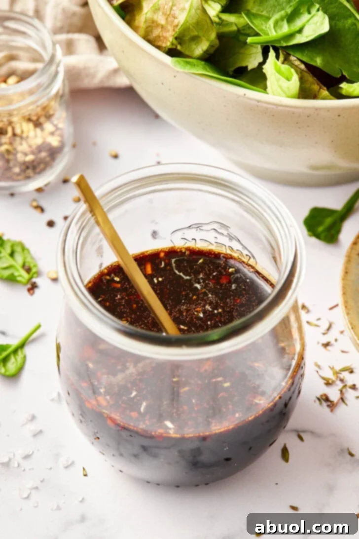 Balsamic Dressing Recipe - Homemade balsamic salad dressing in jar with spoon.
