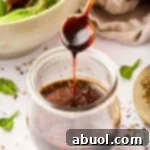 homemade salad dressing with balsamic vinegar poured over jar
