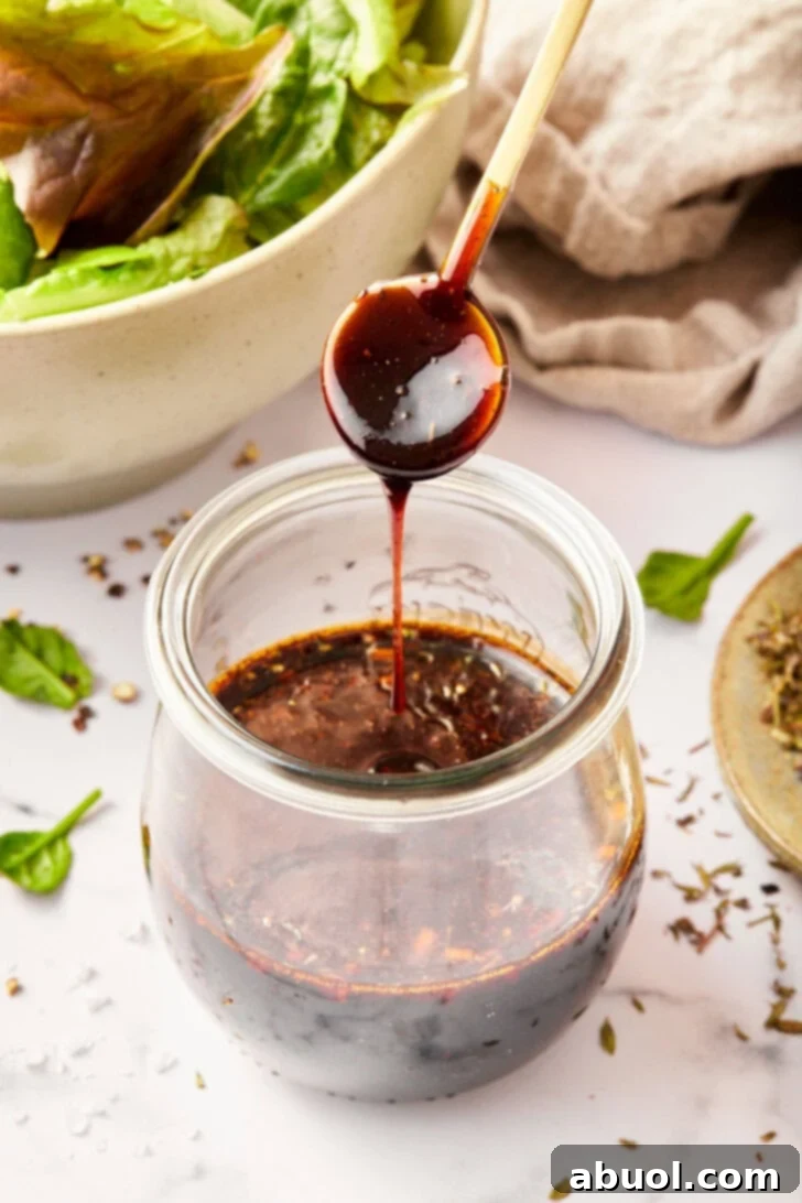 homemade balsamic salad dressing with balsamic vinegar poured over jar