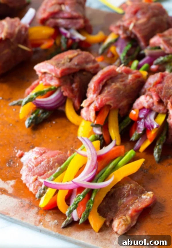 Rolling and securing Low Carb Steak Fajita Roll-Ups with toothpicks
