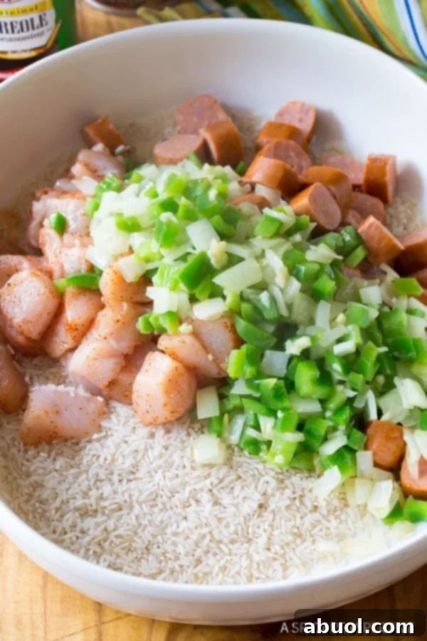 Rice, chicken, sausage and veggies in a baking dish. 