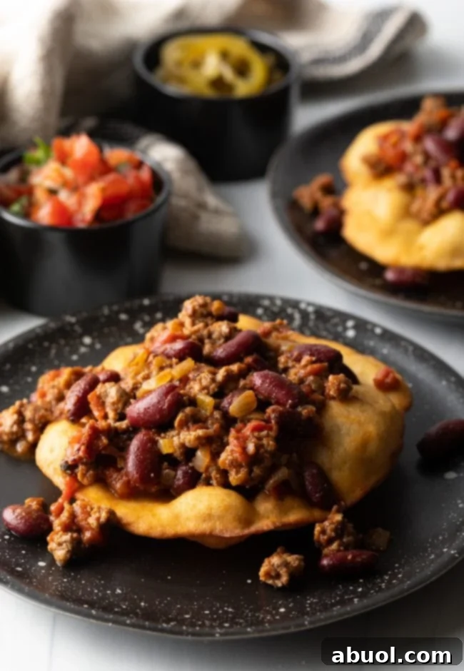 Hearty taco meat and beans perfectly spooned onto a crispy tortilla, ready for toppings.